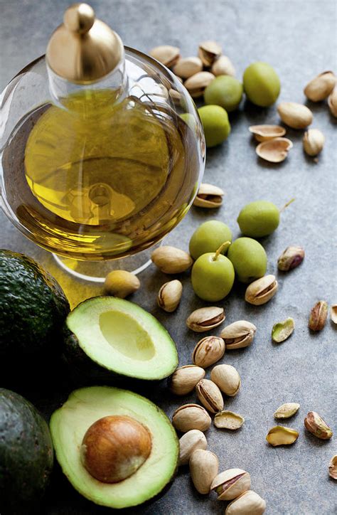 Healthy Fats A Jar Of Olive Oil With Olives Pistachio Nuts And