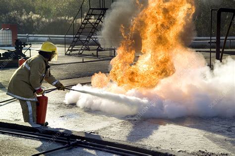 Firefighter Extinguishing A Fire Stock Image T Science