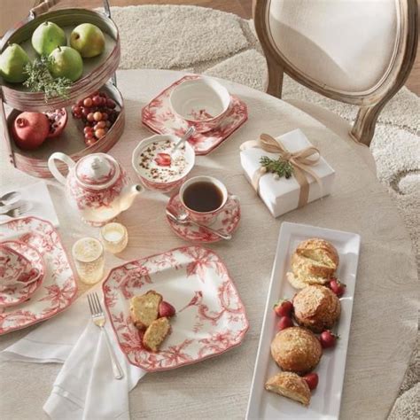 A Table Topped With Plates And Cups Filled With Food Next To A Bowl Of