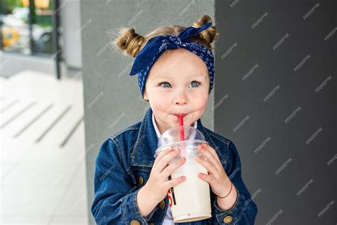 Premium Photo Portrait Of Adorable Little Girl Drinking Milkshake In