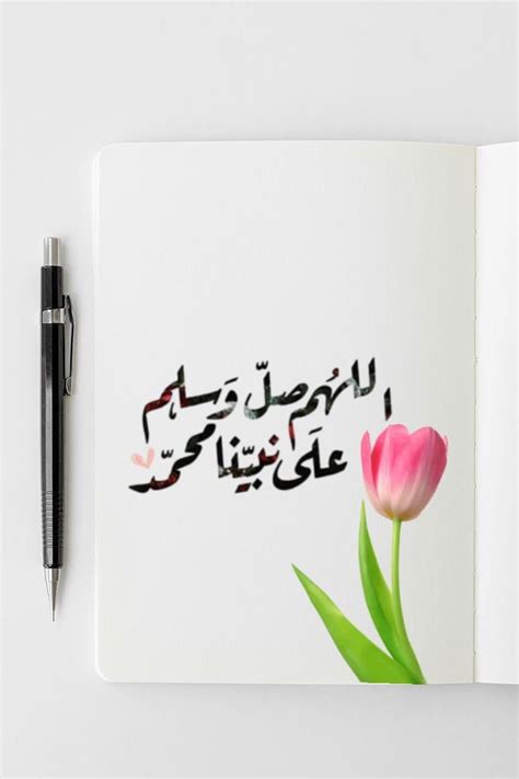 An Open Notebook With Arabic Writing And A Pink Tulip