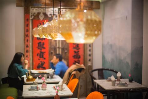 Premium Photo Man And Woman Sitting At Table In Restaurant