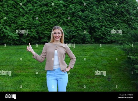 Slender Blonde Smiles And Shows Gesture Of Cool Enjoying Life And New Day Advertises And