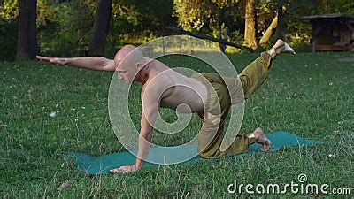 The Guy With The Naked Torso Engages In The Gymnastics Of Yoga