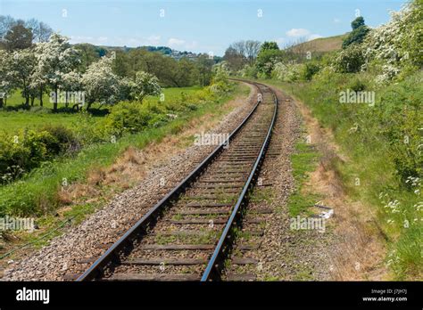 A single track, rural standard gauge railway line on a curve in open country Stock Photo - Alamy