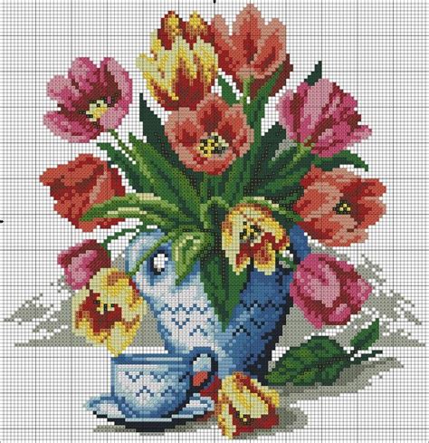 A Cross Stitch Pattern With Flowers In A Vase