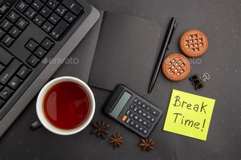 Top View Black Notepad Cup Of Tea Keyboard Calculator Pen Break Time