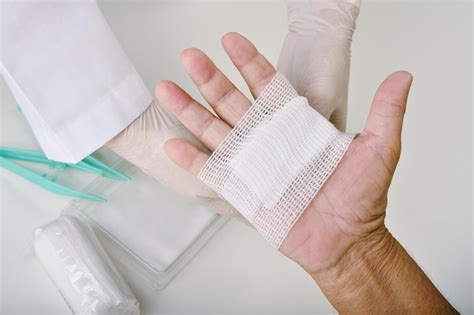 Premium Photo Doctor Doing Wound Dressing Care And Bandaging