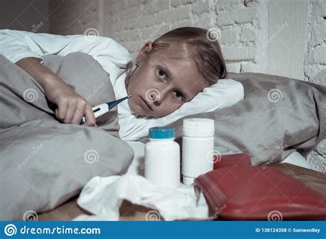 Little Girl Lying Sick In Bed Checking Thermometer Feeling Sick With