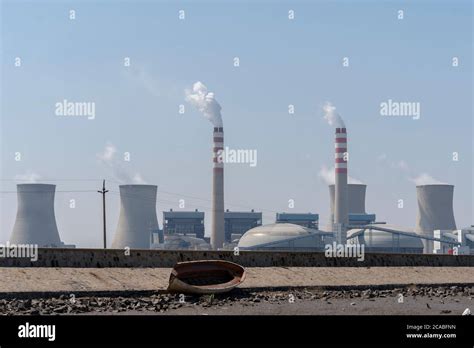 Chimneys Of A Power Plant Emitting Smoke Into Blue Sky Stock Photo Alamy