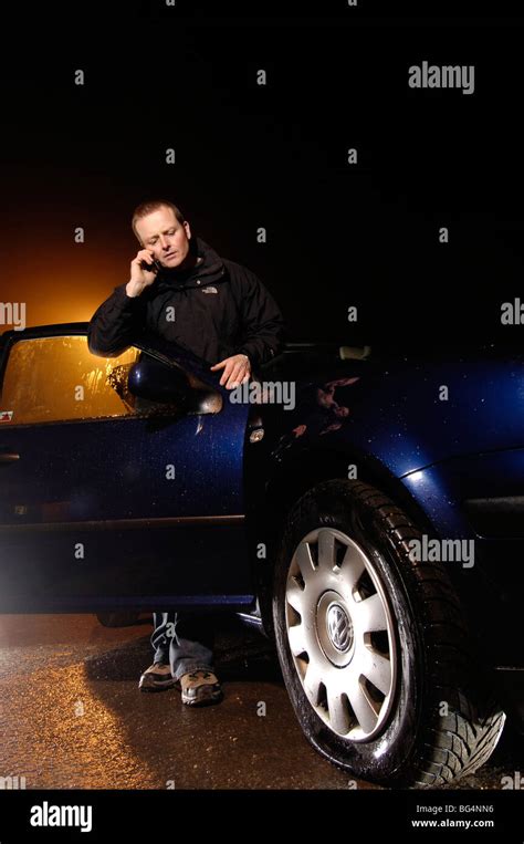 Man With Flat Tyre On Car In The Dark Stock Photo Alamy