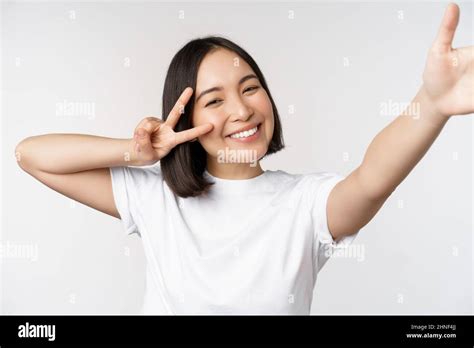 Beautiful Young Asian Woman Taking Selfie Posing With Peace V Sign