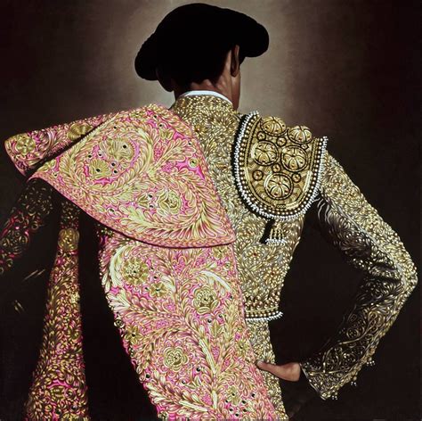 The Back Of A Man In An Elaborately Designed Suit With His Hands On