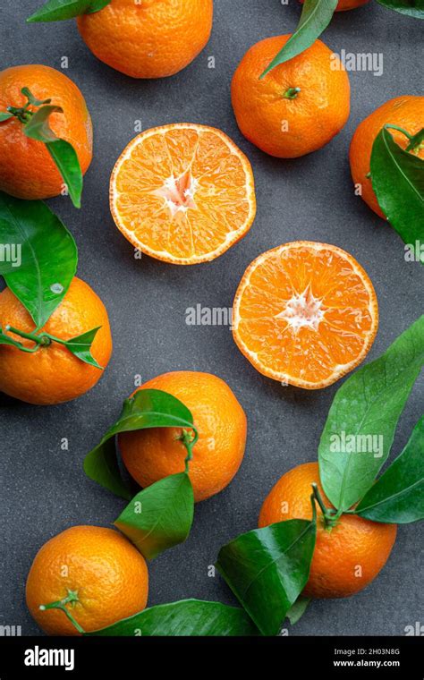 Half And Whole Clementine And Leaf On Darkbackground Stock Photo Alamy