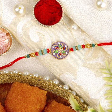 Send Round Floral Rakhi With Motichoor Ladoo Online RKH22 107403