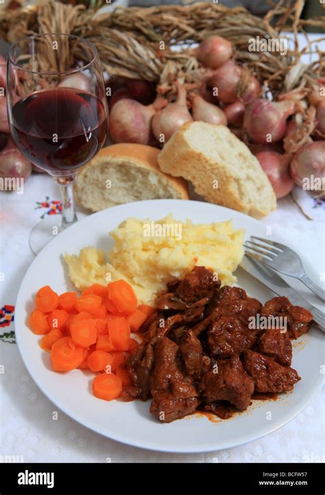 A Meal Of Boeuf Bourguignonne Stew With Wing And Bread Stock Photo Alamy