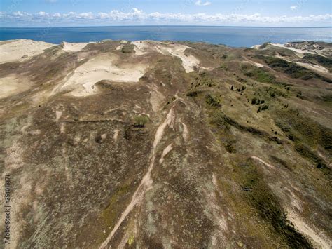 Aerial view with dunes, forest and sea in Curonian spit on a sunny day ...