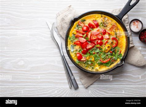 Healthy Frittata In Cast Iron Pan With Fried Beaten Eggs And Seasonal