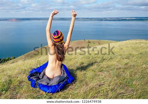 Back View Of Sexy Naked Woman Tourist In A Funny Hat From Nepal Sitting