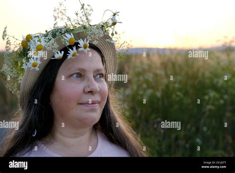 Happy Smiling Woman In Flower Wreath On Green Sunny Meadow Floral