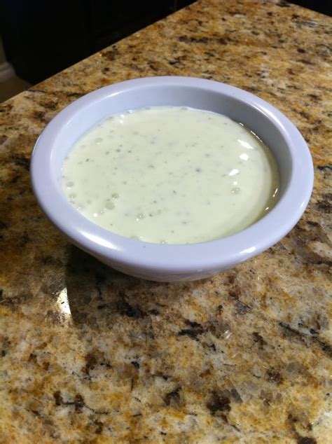 A White Bowl Filled With Liquid Sitting On Top Of A Counter