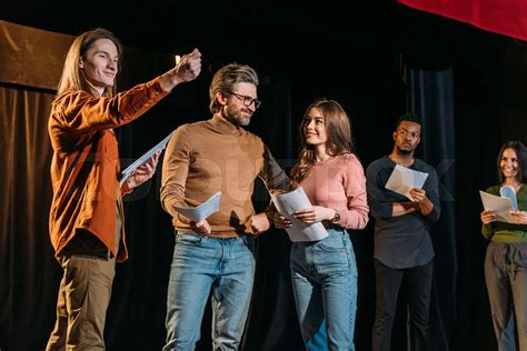 Multicultural Actors And Actresses Rehearsing On Stage In Theatre