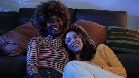 Happy Multiracial Lesbian Couple Looking Each Other Portrait Of A Beautiful Young Couple Lying