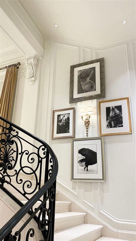 There Are Pictures On The Wall Next To The Stair Railing And Framed