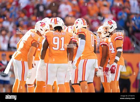 The Tampa Bay Buccaneers Defensive Line Huddles During An Nfl Football