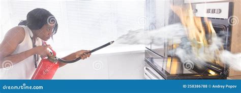 Using Fire Extinguisher in Kitchen Stock Photo - Image of house ...