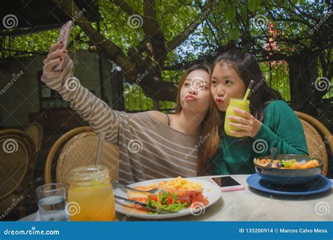 Young Happy And Cute Asian Chinese Girlfriends Taking Selfie Portrait