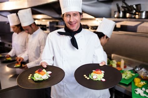 Premium Photo Happy Head Chef Presenting His Food Plates