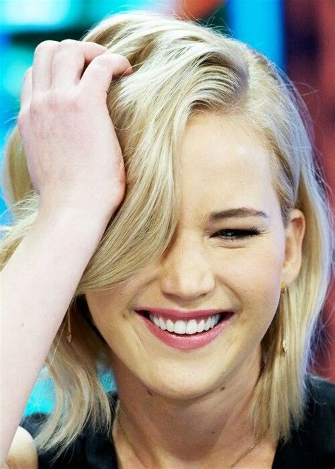 A Close Up Of A Person Smiling And Holding Their Hand On Her Head With