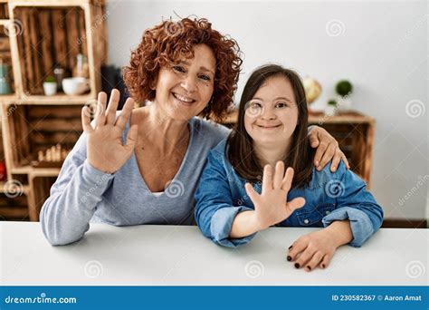 Mature Mother And Down Syndrome Daughter At Home Taking A Picture Stock