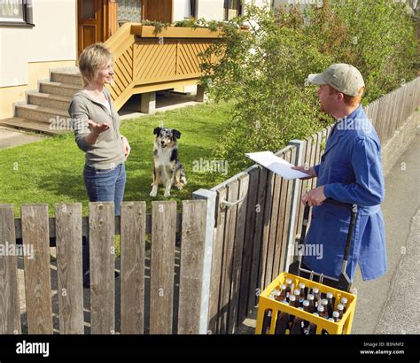 Woman With Australian Sheperd And Beverages Deliverer Stock Photo Alamy