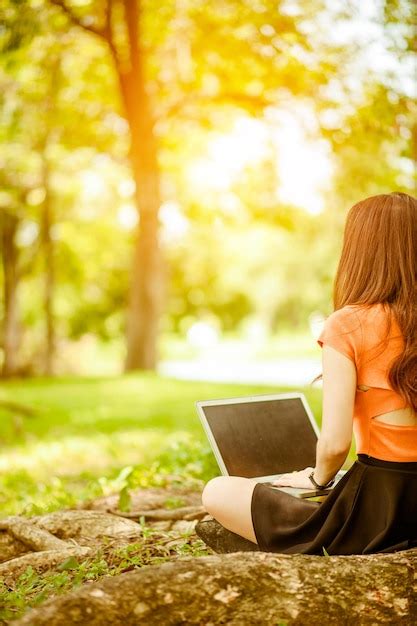 Premium Photo Woman Reading Book While Sitting On Land