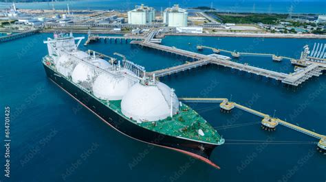 LNG (Liquified Natural Gas) tanker anchored in Gas terminal gas tanks ...