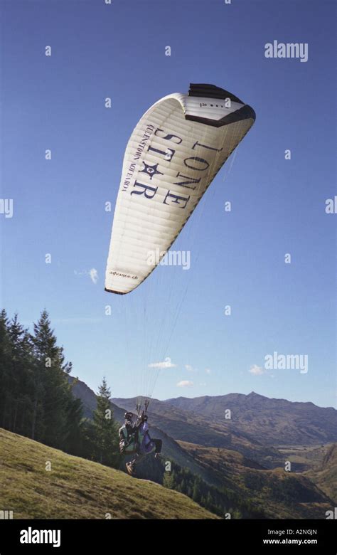 Tandem Paraglider Launches Off Over Queenstown New Zealand Stock Photo