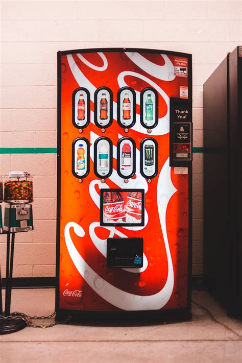 Bright Soda And Candy Machines In Building · Free Stock Photo