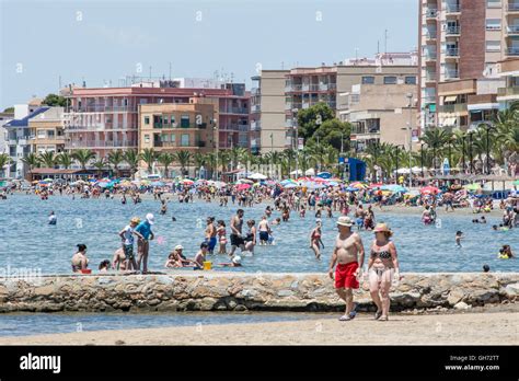 Tourists On The Beach And In The Mar Menor At Lo Pagan In Murcia Spain