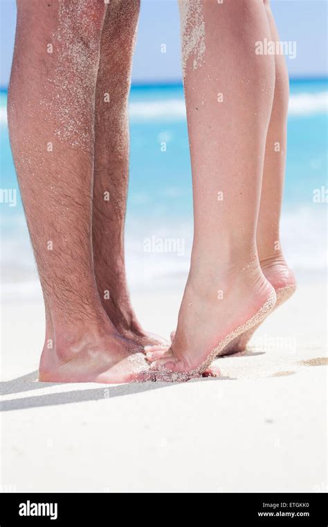 Womans Barefoot Legs Standing Up Tiptoe Closeup To Male Foot And