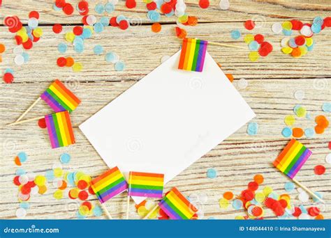 Bright Rainbow Gay Flag On Wooden Background Paper Confetti Top View With Space For Text Mocup
