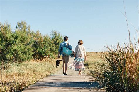 «Back View Of Young Pregnant Couple And Their Dog Walking On The Beach ...