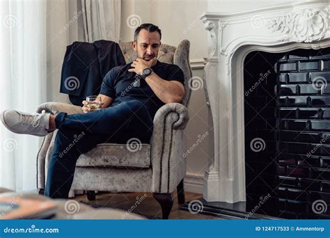 Mature Business An Sitting In Hotel Room With A Glass Of Whisky Stock Image Image Of Casuals