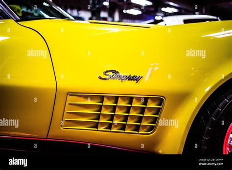 A beautiful yellow corvette with the Stingray logo on the side Stock ...