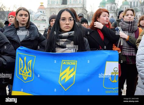 A woman holds a flag with the symbols of the AZOV battalion, during the ...