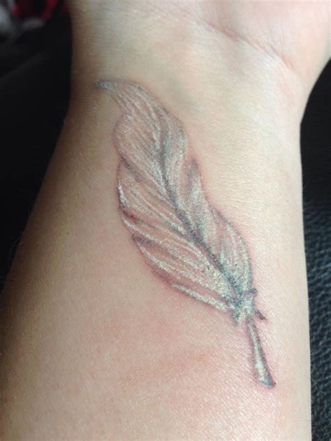 Realistic White Ink Feather Tattoo On Wrist Tattooimages Biz