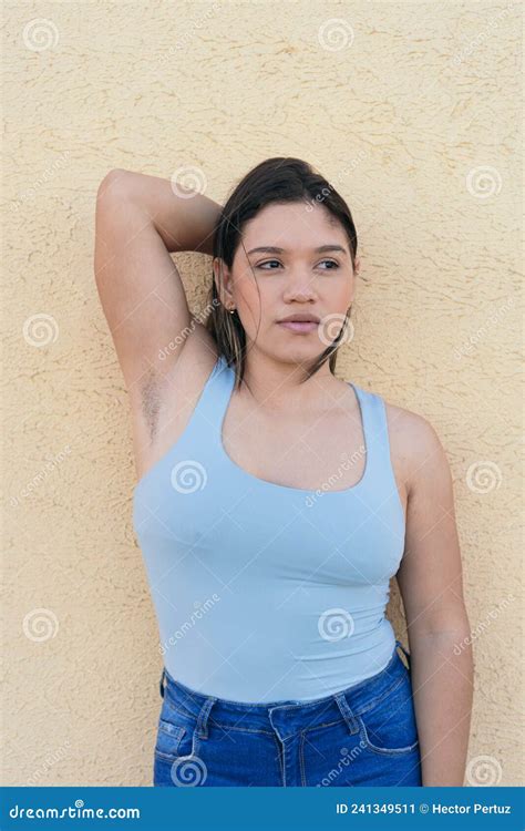 Young Natural Woman With Unshaven Armpits Looking To The Side Stock