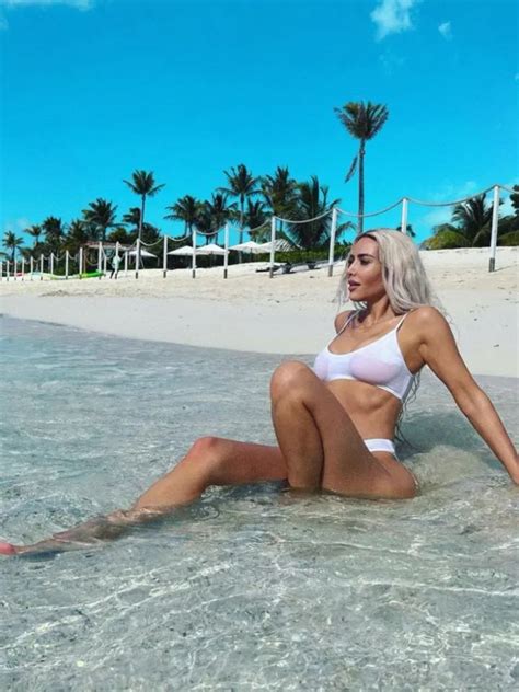 Kim Kardashian Hits The Beach In See Through White Bikini Top