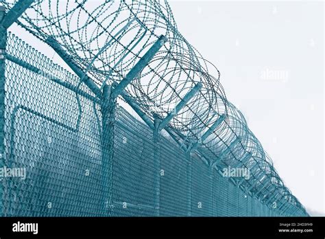 Prison fence. Barbed wire Stock Photo - Alamy